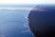 Oblique aerial photo of barrier spits backed by wind tidal flats.