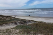3. The dunes and beach. The motorcyclist is using the beach as a highway