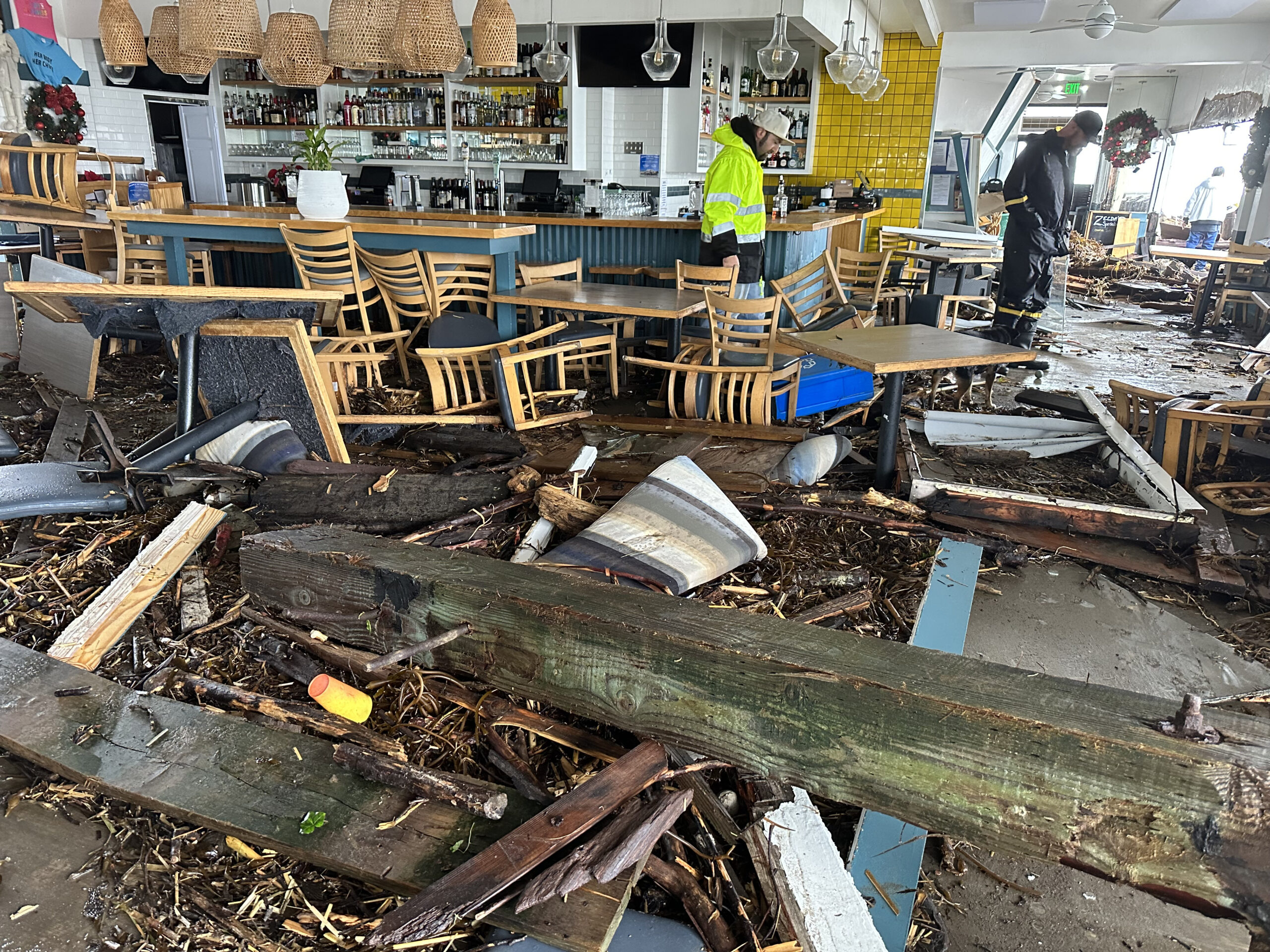 Kitchen manager Josh Whitby inspects the wreckage of Zelda's on the Beach Thursday afternoon in Capitola Village after the restaurant sustained major damage from the storm © 2023 Shmuel Thaler - Santa Cruz Sentinel