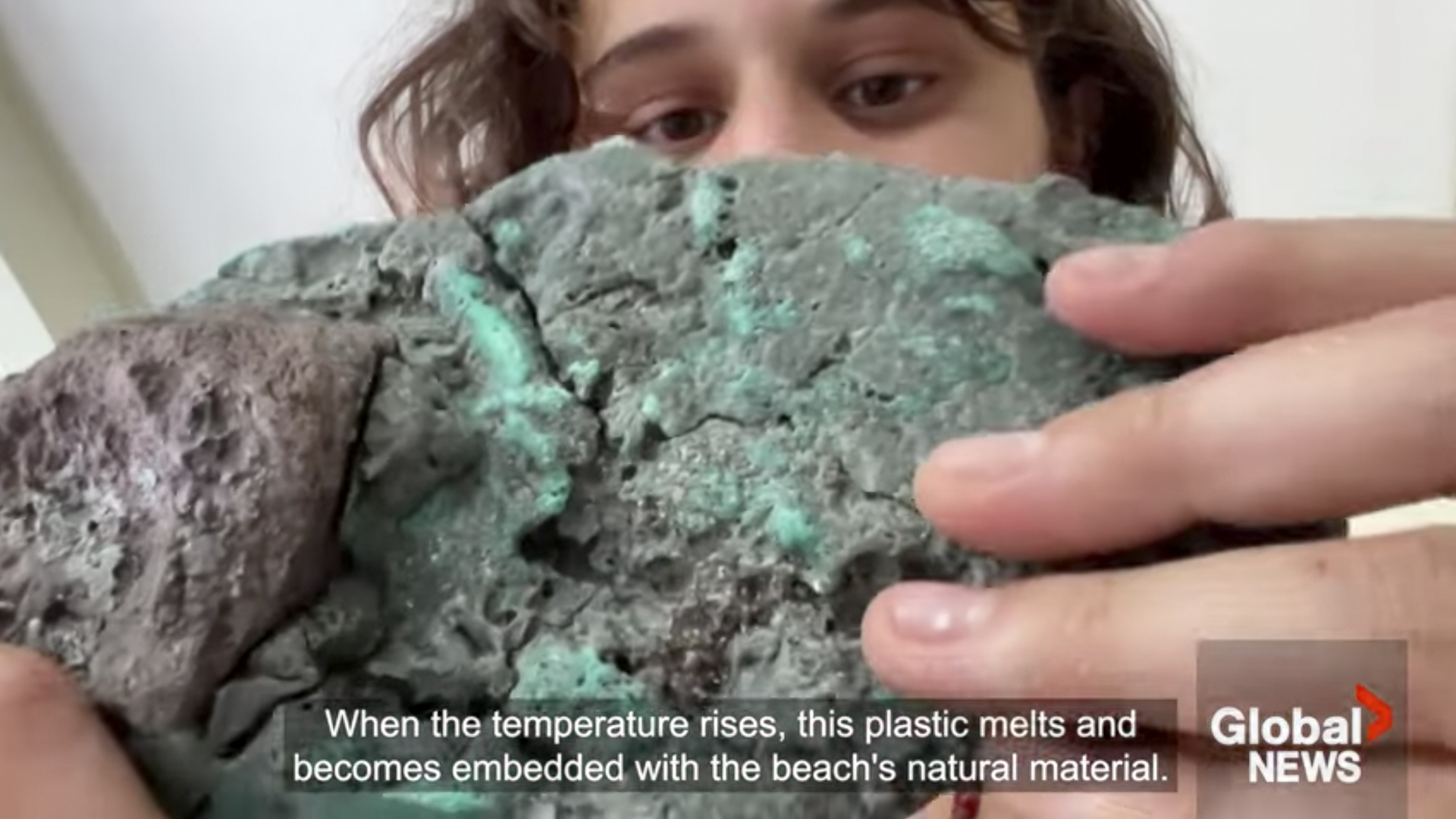 Rocks called "plastiglomerates" - because they are made of a mixture of sedimentary granules and other debris held together by plastic, mainly fishing nets - have been found in Brazil's volcanic Trindade Island. Researchers view this as evidence of humans' growing influence over the earth's geological cycles (screenshot taken from Global News video "Mutated "plastic rocks" discovered on remote Brazilian island," March 23, 2023, via Youtube).