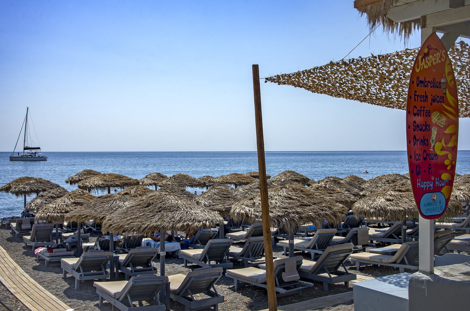 Densely packed sun beds on the Santorini coast, Greece © 2023 Deepika Shrestha Ross