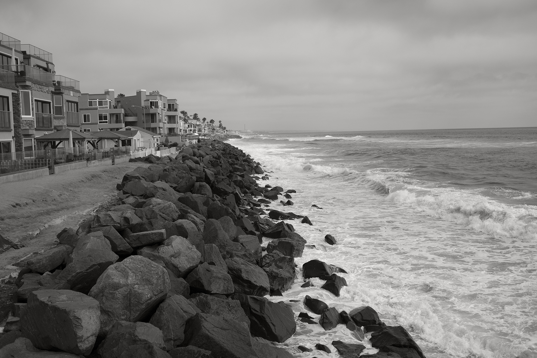 Riprap-lined beaches along the southern coast of Oceanside, California. This image was taken at a medium high tide in August 2019. Much of the southern coast of Oceanside has a similar profile, with riprap and short to non-existent beaches © 2019 Ryan Anderson.