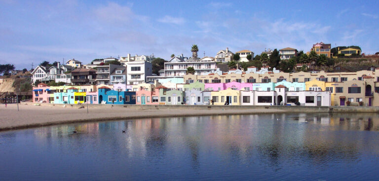Mediterranean style beach cottages at Capitola-by-the-Sea. The lagoon is formed by Soquel Creek. California, Capitola. 2003 October (Courtesy of NOAA Photo Library, photo by Captain Albert E. Theberge, NOAA Corps (ret.) CC BY 2.0 DEED via Flickr).