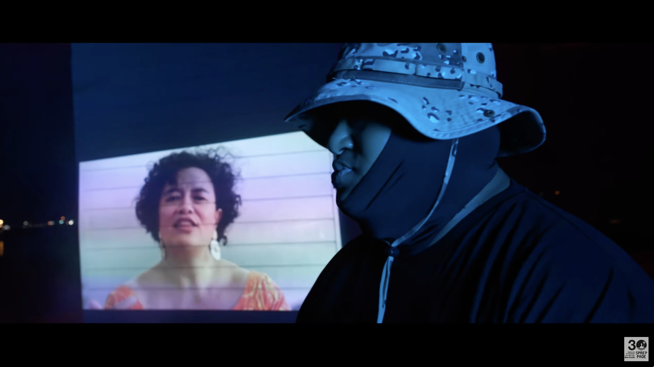 Screenshot featuring poet Audrey Brown-Pereira and hip-hop artist Anonymouz from "They taking pictures of us in the water" Pacific Regional Environment Programme (SPREP) via Youtube)