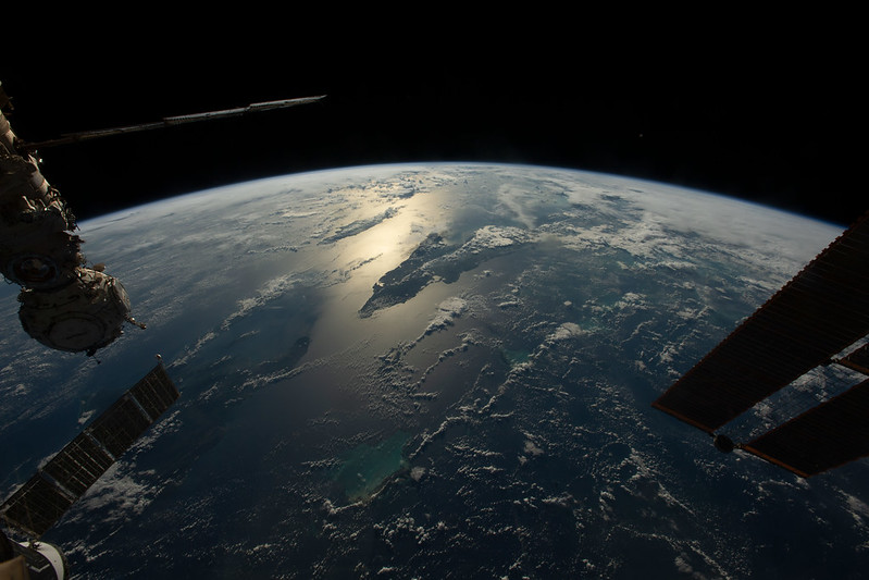 The sun's glint beams across the Caribbean Sea and the Atlantic Ocean highlighting Cuba and Haiti in this photograph from the International Space Station as it orbited 258 miles above, Nov. 20, 2022 (courtesy of NASA Johnson CC BY-NC-ND 2.0 DEED via Flickr).