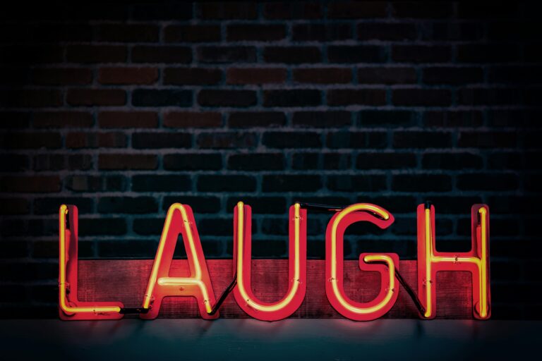 Laugh Neon-light Signage Turned on (by Tom Mossholder via Pexels).
