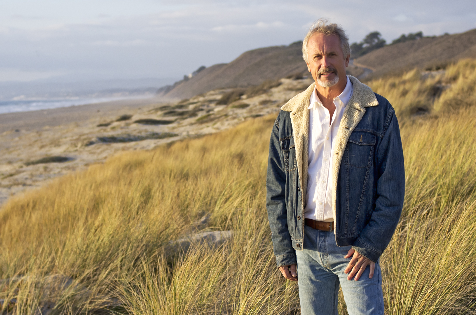 Coastal Geologist. Oceanographer and University of California Santa Cruz professor Gary Griggs stands in the sand dunes along Monterey Bay © D Shrestha Ross.