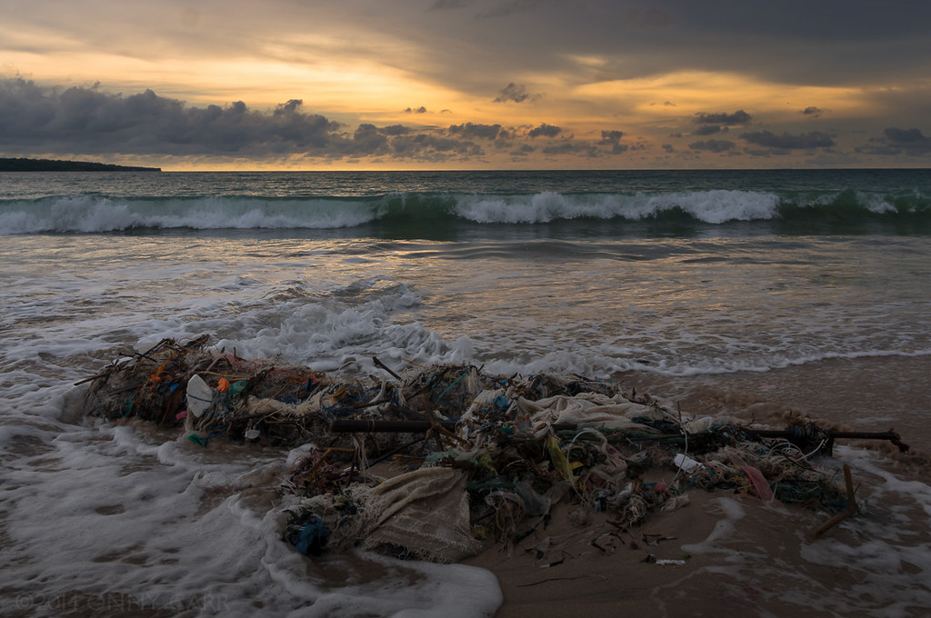 Beautiful Bali: Plastic bags, bottles and other trash entangled in spent fishing nets litter the Jimbaran beach on the island of Bali, Indonesia, 2014 (by Onny Carr CC BY-NC-ND 2.0 via Flickr).