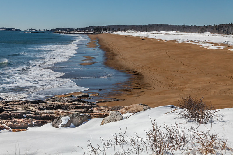 "White And Brown And Blue" A view down the One Mile beach at Reid State Park in Geogetown, Maine (by Paul VanDerWerf CC BY 2.0 via Flickr).