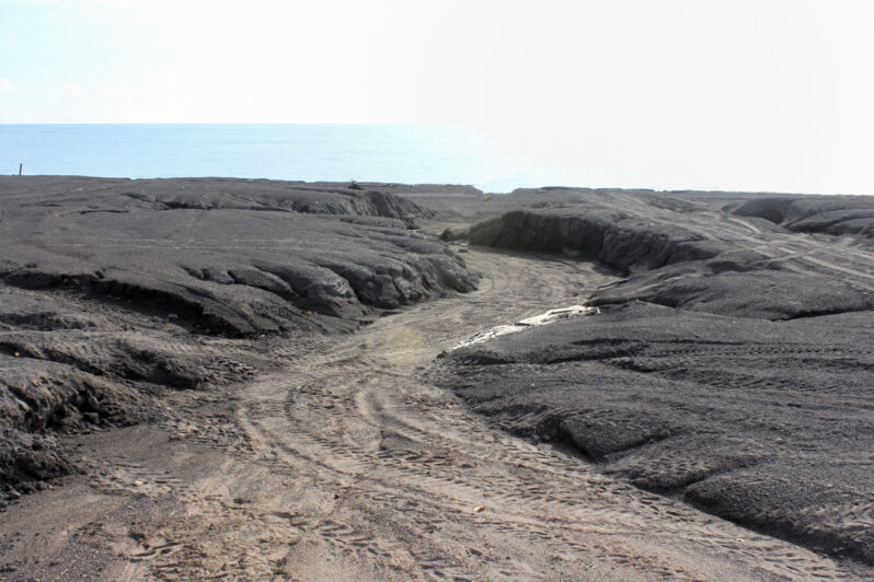 Figure 13. Flooding from landward runoff has cut a channel across the stamp sands, suggesting there is enough clay content to retard infiltration. The tire tracks suggest it’s a fun ORV drive. Location is in the northern portion of the original deposit shore. (See Figure 3, lower left where the drainage pattern extends across the back beach.)